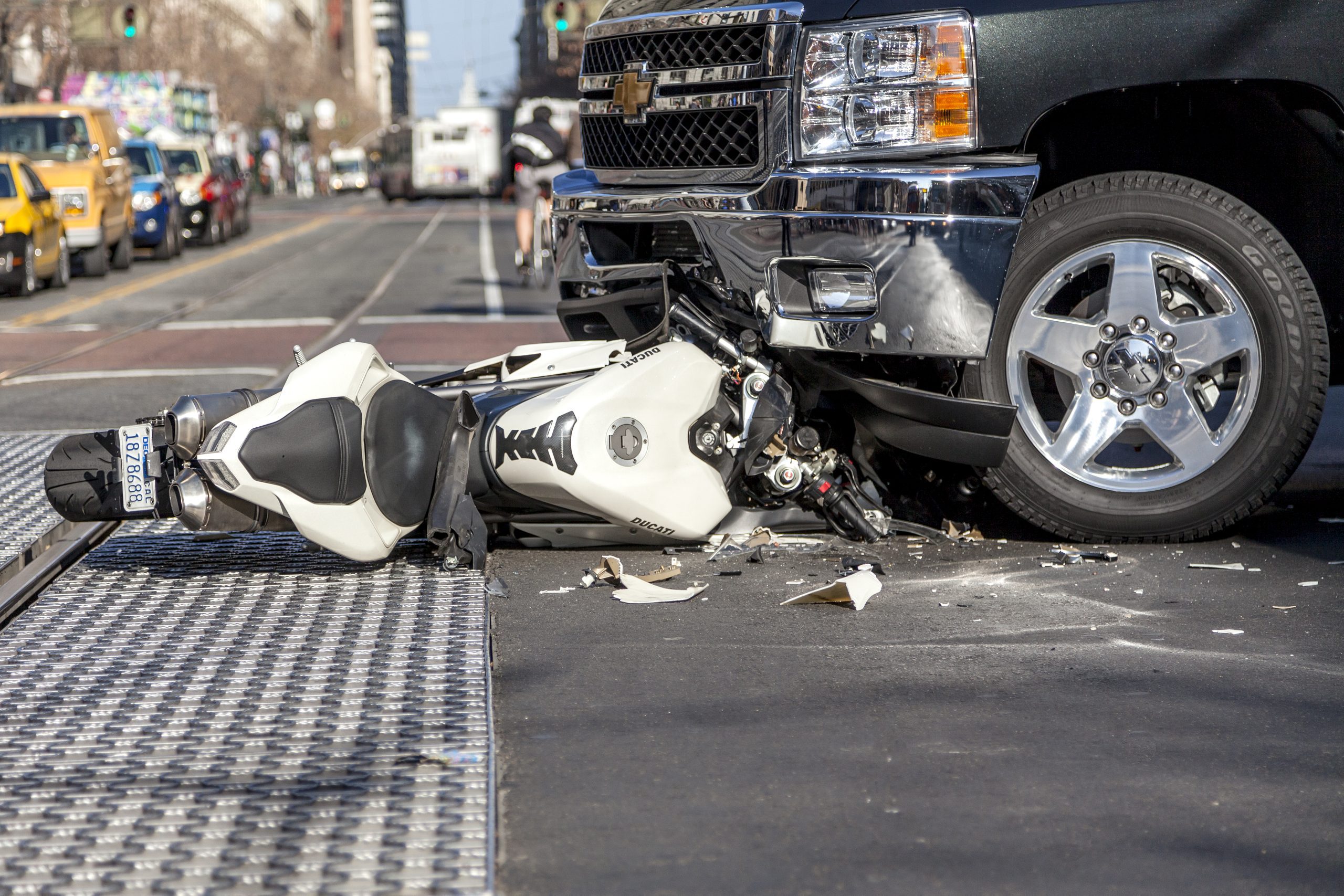 Traffic accident between a white Ducati motorcycle and Chevy pickup truck